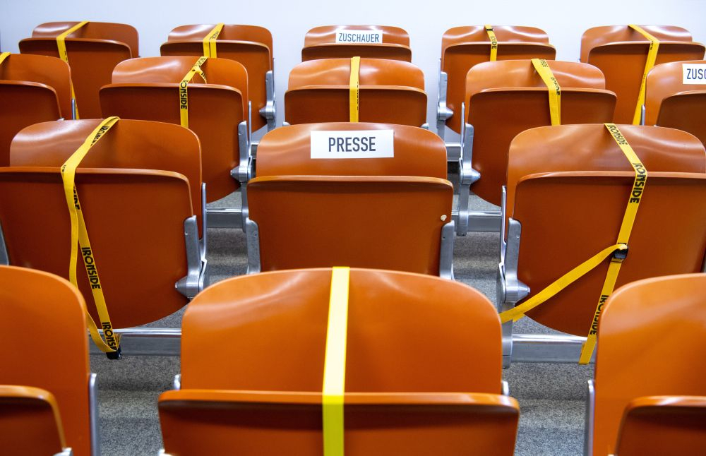 Gesperrte Sitzplätze im Zuschauerraum eines Gerichtssaals aufgrund der Abstandsregeln in der Coronapandemie. Abbildung: Sven Hoppe, Picture Alliance/dpa